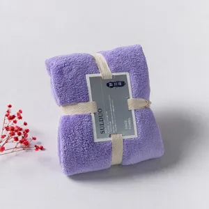 Thickened coral fleece face towel in elegant purple with ribbon, soft and absorbent.