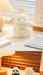 Close-up view of a FOFO animal rabbit resin figurine in a serene praying pose on a desk.