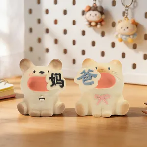 Detailed shot of cute resin cat and dog figurines holding Mom and Dad signs