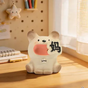 Close-up of cute resin cat figurine holding a speech bubble on a sunlit desk