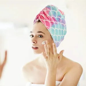 Close-up scene of a model wearing a soft microfiber fish scale dry hair cap while skincare.