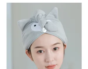 Close-up detail of soft grey coral fleece dry hair cap with cute animal ears and secure button.