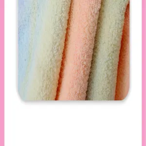 Close-up detail of soft coral fleece fabric, highly absorbent and fluffy texture.