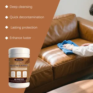 Leather care wipes being used to clean and protect a brown leather sofa surface