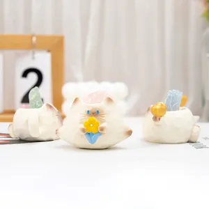 Detailed view of cute cat resin figurines holding energy crystals for home and office decor
