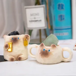 Detailed view of two cute cat-shaped resin figurines with natural energy crystals
