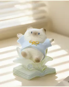 Détail macro d'une figurine de chat mignon avec chemise bleue et lumière douce de store
