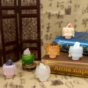 Variety of colorful resin Buddha head figurines with raw natural crystals home decor