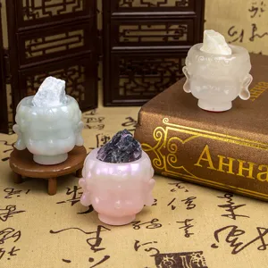 Artistic Buddha head resin figurines holding raw crystals for home decor display.
