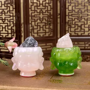 Detailed close-up of resin Buddha head ornaments featuring natural raw crystal stones