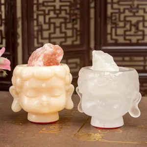 Detailed view of two cute Buddha head resin figurines featuring natural mineral stones