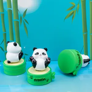 Detailed view of cute panda resin figurines on green bamboo bases with embossed text