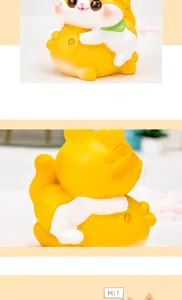 Close-up macro view of a cute resin cat figurine hugging a giant golden fish ornament
