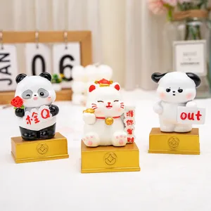 Group of cute cartoon resin figurines on golden bases for office desk decoration