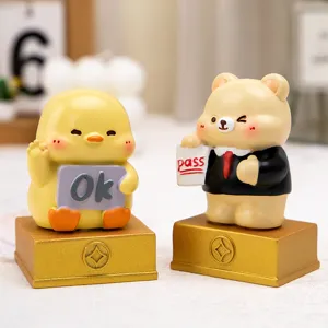 Detail shot of cute cartoon chick and bear resin figurines for office desk decor