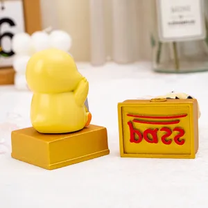 Close-up of resin cartoon duck doll and golden stamp base with red pass text