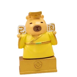 Cute cartoon Capybara resin figurine wearing yellow imperial robe for desk decor.