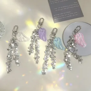 Detail of angel wing keychains with cascading silver stars in four pastel colors