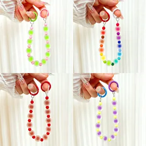 Close-up of vibrant handmade jelly beaded phone charms in four unique colorful styles
