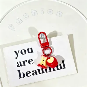High quality close-up of cute red apple and bitten core keychain charms for bags