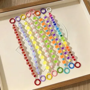 Vibrant dopamine-style frosted jelly beaded phone chains and keychains in a display tray