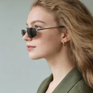 Close-up side profile of a model wearing retro Y2K metallic square frame sunglasses