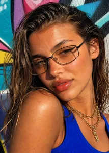 Stylish Y2K metal square sunglasses on a female model with street graffiti background