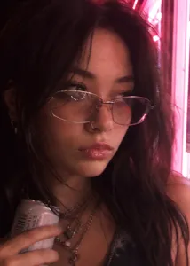 Stylish Y2K metallic square frame sunglasses worn by model in pink neon light setting