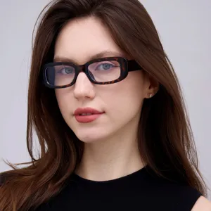 Close-up portrait of a woman wearing retro leopard print small square frame glasses.