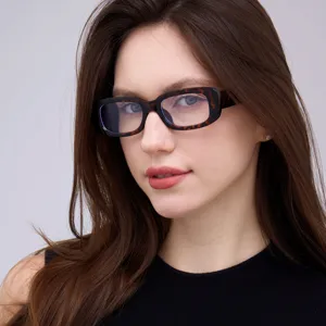 Detailed view of retro tortoiseshell square frame glasses worn by a stylish female model