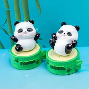 Detailed view of cute panda resin rotating blind box figurines on green bamboo style bases