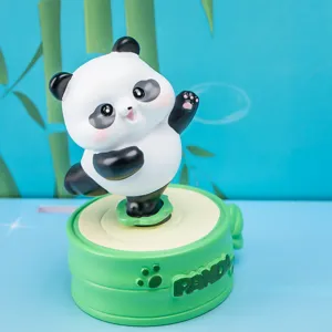 Close-up of a cute Panda rotating resin figurine with 'PANDA' embossed base