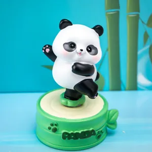 Detailed view of a cute panda rotating resin ornament with a green bamboo base