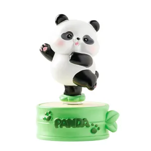 Cute cartoon panda resin figurine on a green bamboo base for desktop decoration