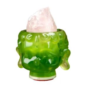 Green resin Buddha head figurine topped with natural pink raw crystal for home decor.