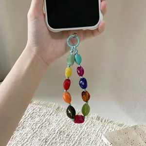 Detailed view of a colorful irregular beaded phone strap attached to a white mobile case