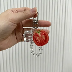 Detailed view of a creative tomato fruit keychain with ice cube charm and clear beads