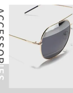 Macro detail of luxury gold metal frame aviator sunglasses with dark lenses