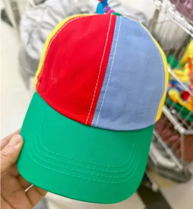 Close-up of a colorful children's propeller baseball cap with red, blue and green panels