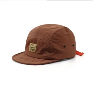Detailed side view of a brown retro five-panel cap with quick-dry fabric and short soft brim