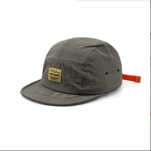 Close-up detail of retro grey 5-panel cap featuring quick-dry fabric and orange strap