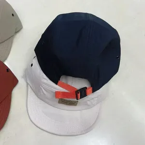 Detailed view of adjustable orange back strap on five-panel quick-dry retro baseball cap