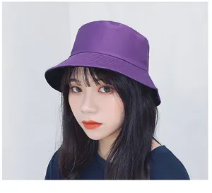 Close-up showing the fit of a purple double-sided cotton bucket hat on a woman