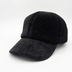 Detailed texture view of a black teddy fleece baseball cap with a corduroy brim.