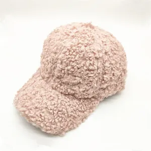 Detail view of pink fuzzy sherpa baseball cap showing its soft teddy fleece texture