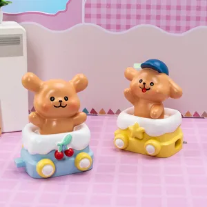 Two cute cartoon puppy figurines sitting in colorful toy train carriages