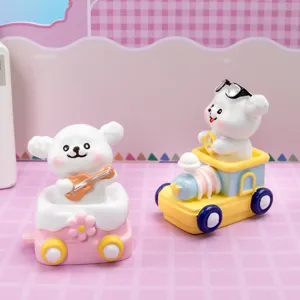 Detailed close-up view of two cute white dog resin figurines on a toy train and car