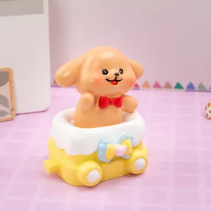 Close-up detail of a cute cartoon dog resin figurine sitting in a colorful toy train.