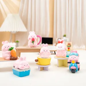 Collection of adorable pink Nini rabbit resin figurines displayed in a miniature room setting