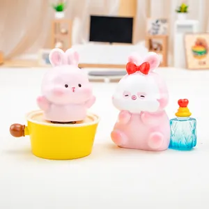 Two cute pink rabbit resin figurines showcased in a creative miniature room setting decor.